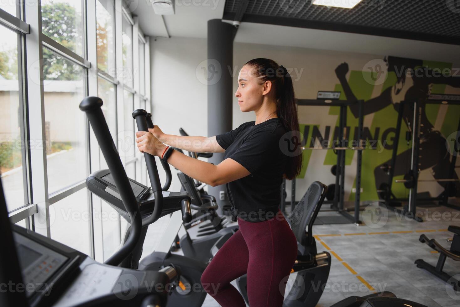 Woman was running on the treadmill in the gym. photo