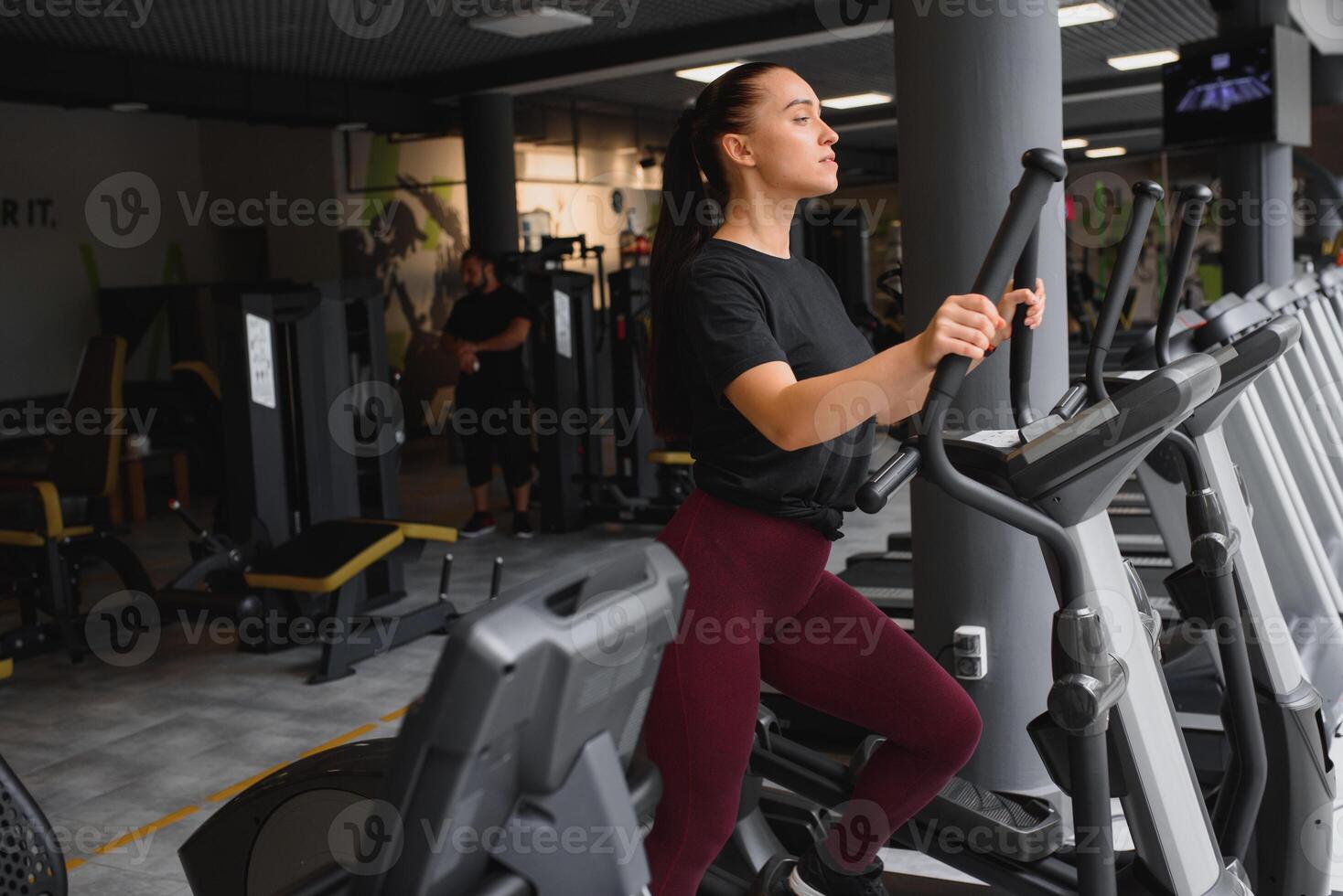 attractive young woman runs on a treadmill, is engaged in fitness sport club. photo