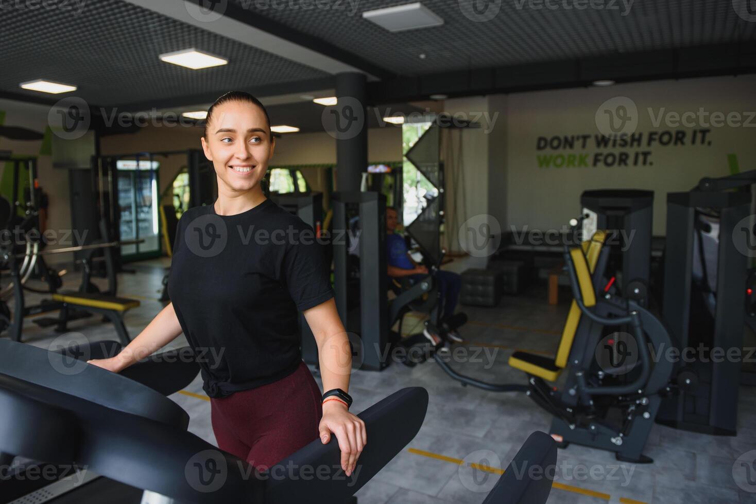 Woman trains on a treadmill in the gym. Young fitness girl running on treadmill machine. Sports exercises for weight loss photo