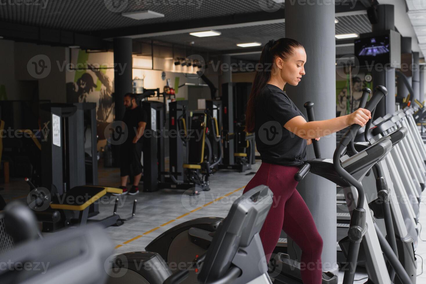 attractive young woman runs on a treadmill, is engaged in fitness sport club. photo