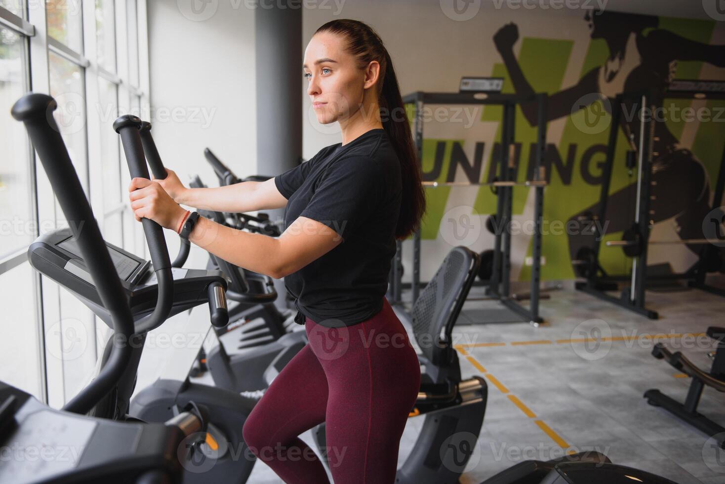 Woman was running on the treadmill in the gym. photo