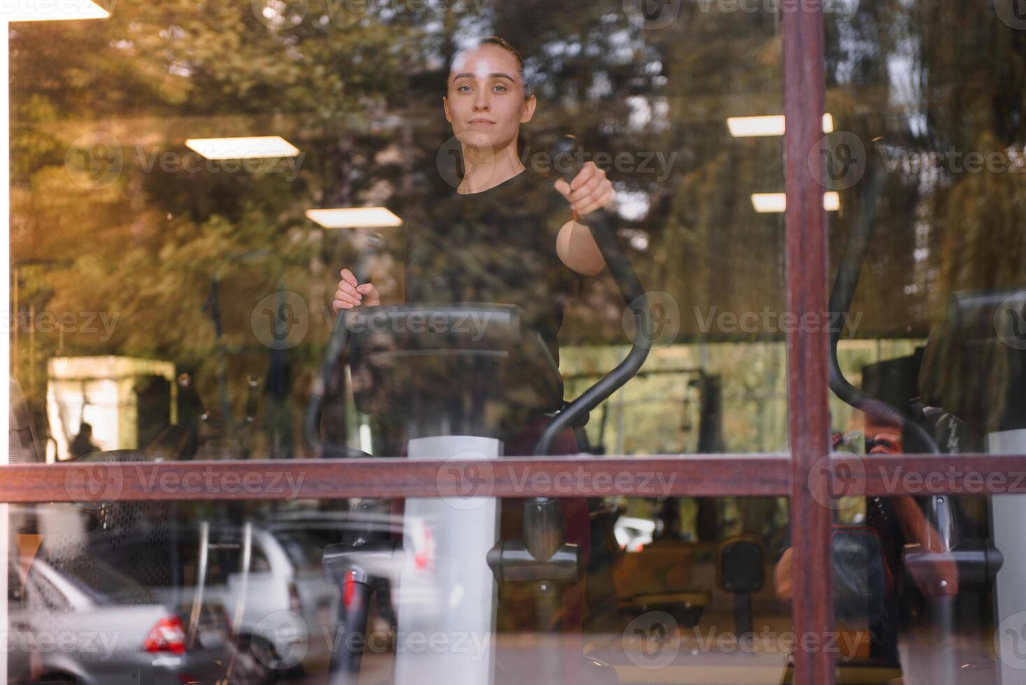 Woman was running on the treadmill in the gym. photo