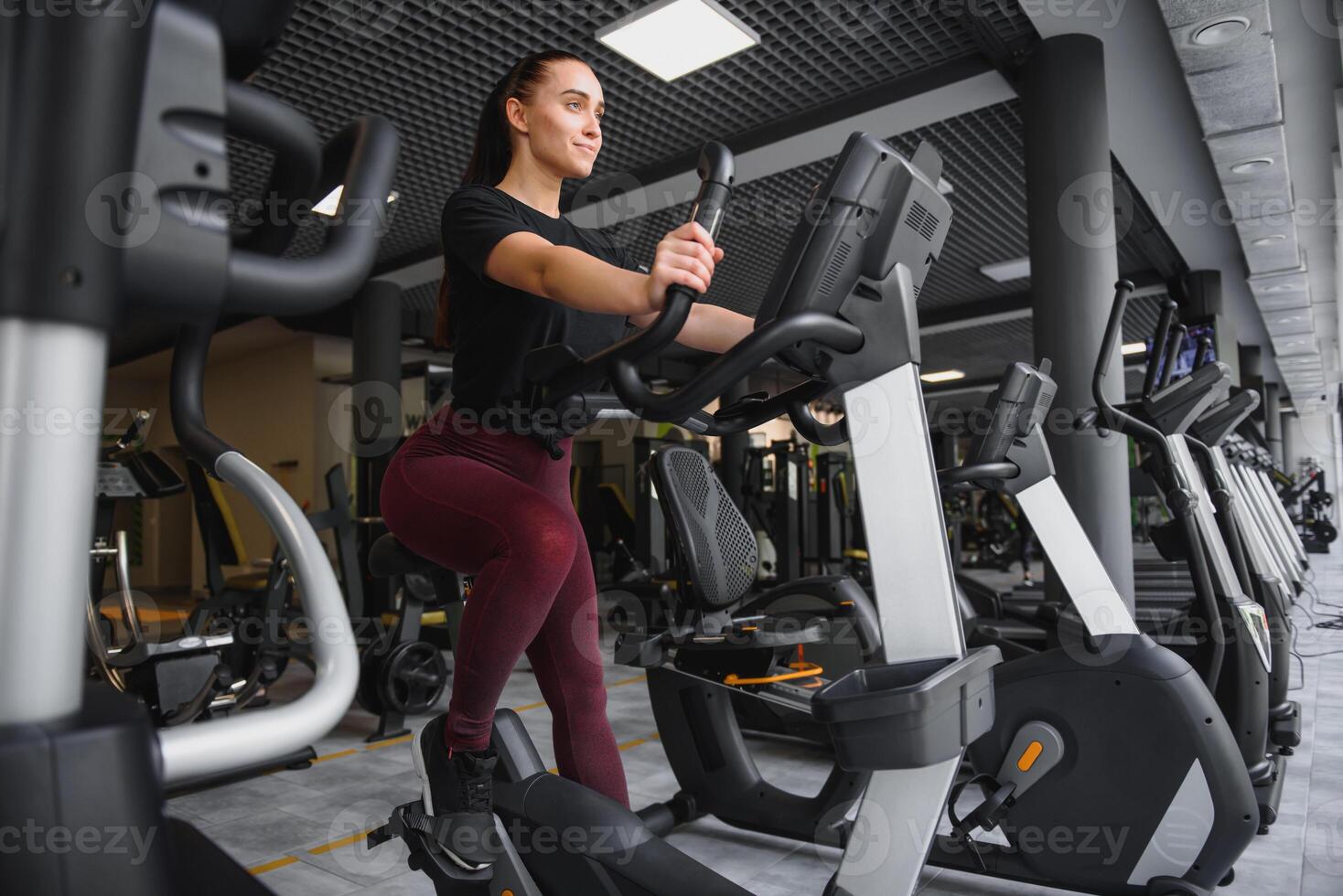 Woman was running on the treadmill in the gym. photo