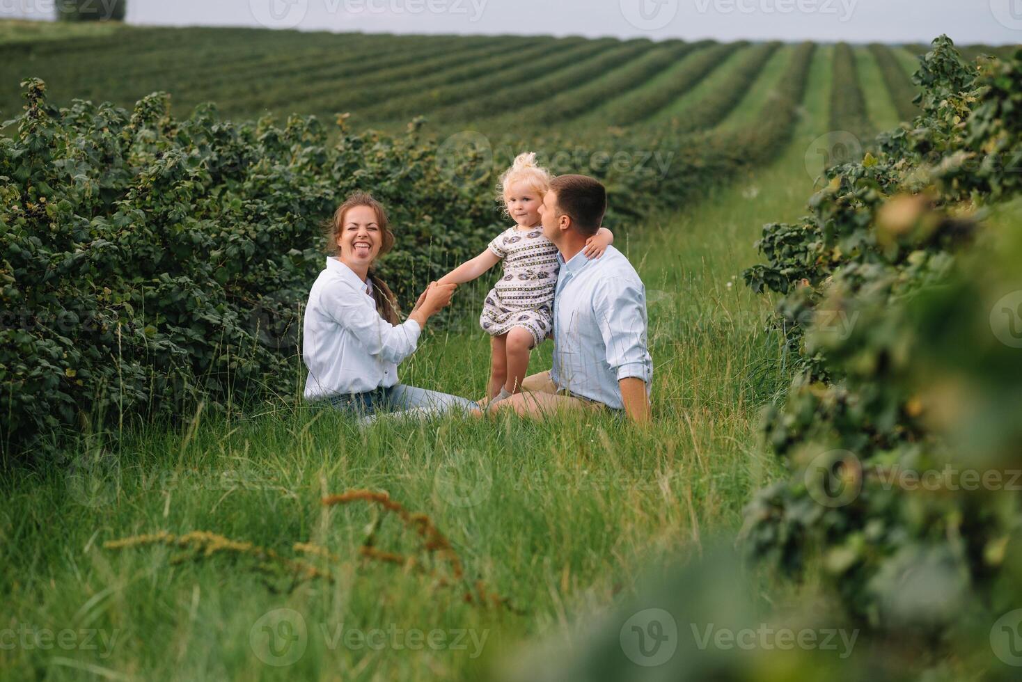 contento familia caminando en el parque. mamá, papá y hija caminar al aire libre, padres participación el bebé muchachas manos. infancia, paternidad, familia cautiverio, matrimonio concepto. foto