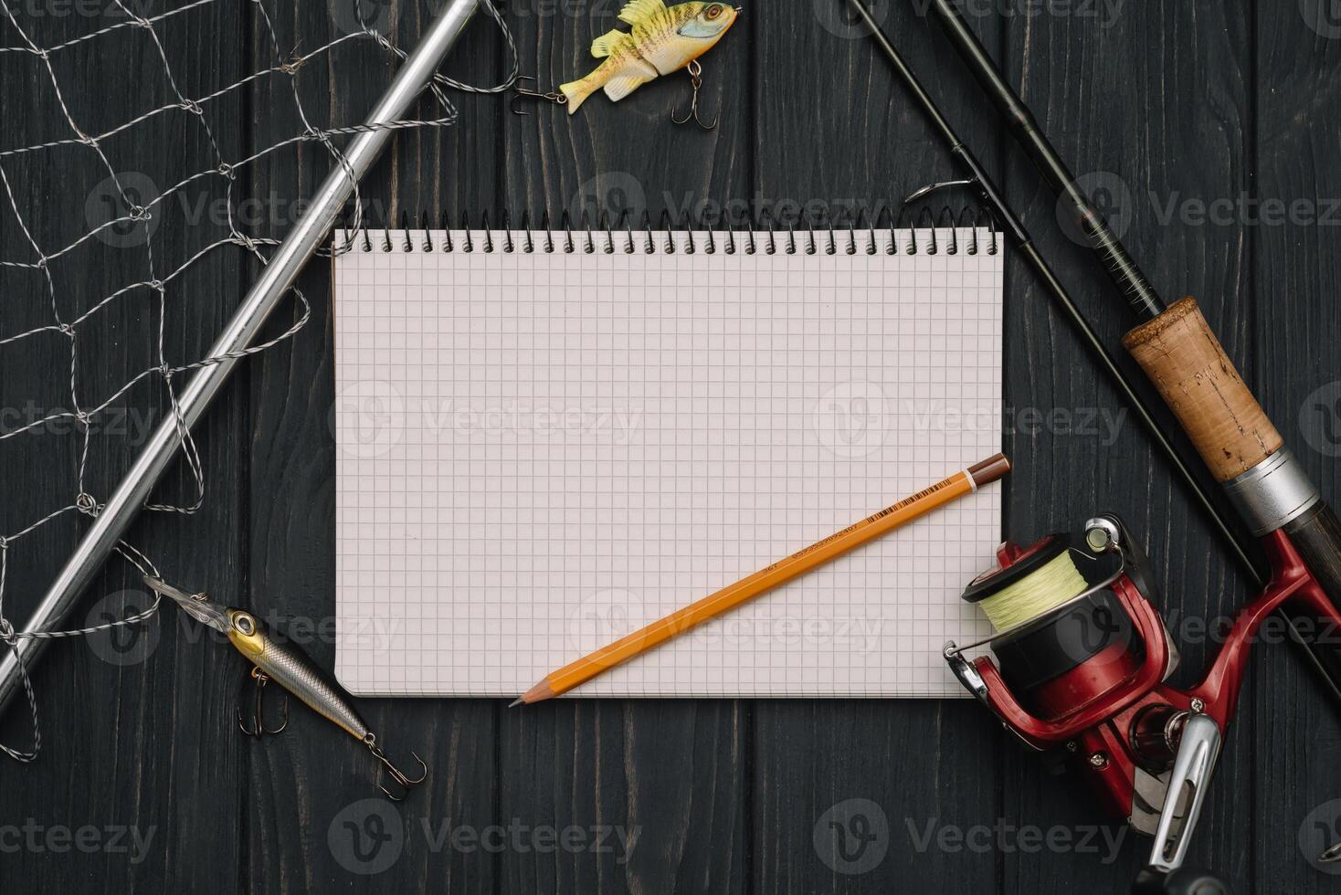 Fishing tackle - fishing spinning, hooks and lures on darken wooden background. Top view photo