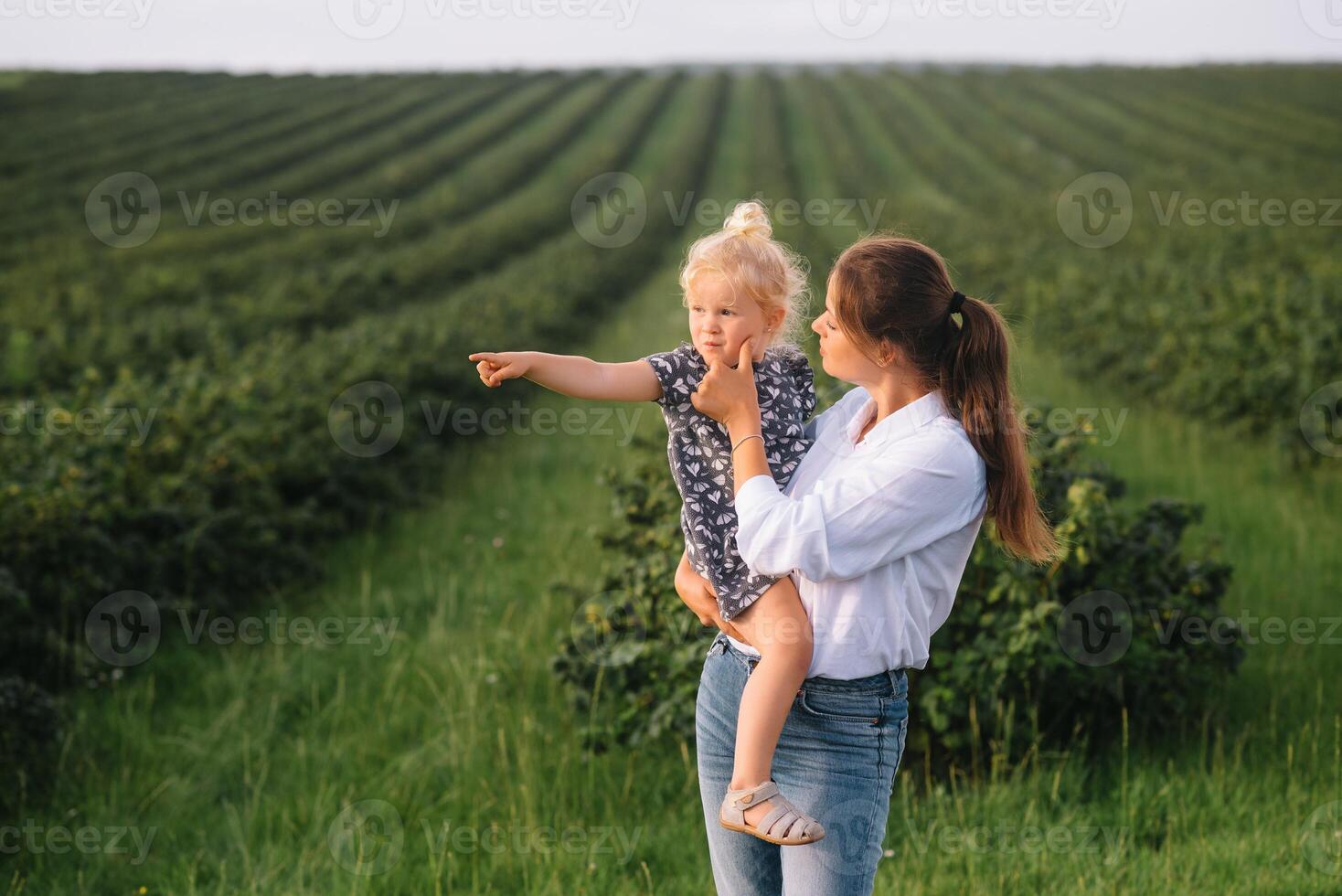 elegante madre y hija teniendo divertido en el naturaleza. contento familia concepto. belleza naturaleza escena con familia al aire libre estilo de vida. contento familia descansando juntos. felicidad en familia vida. madres día foto