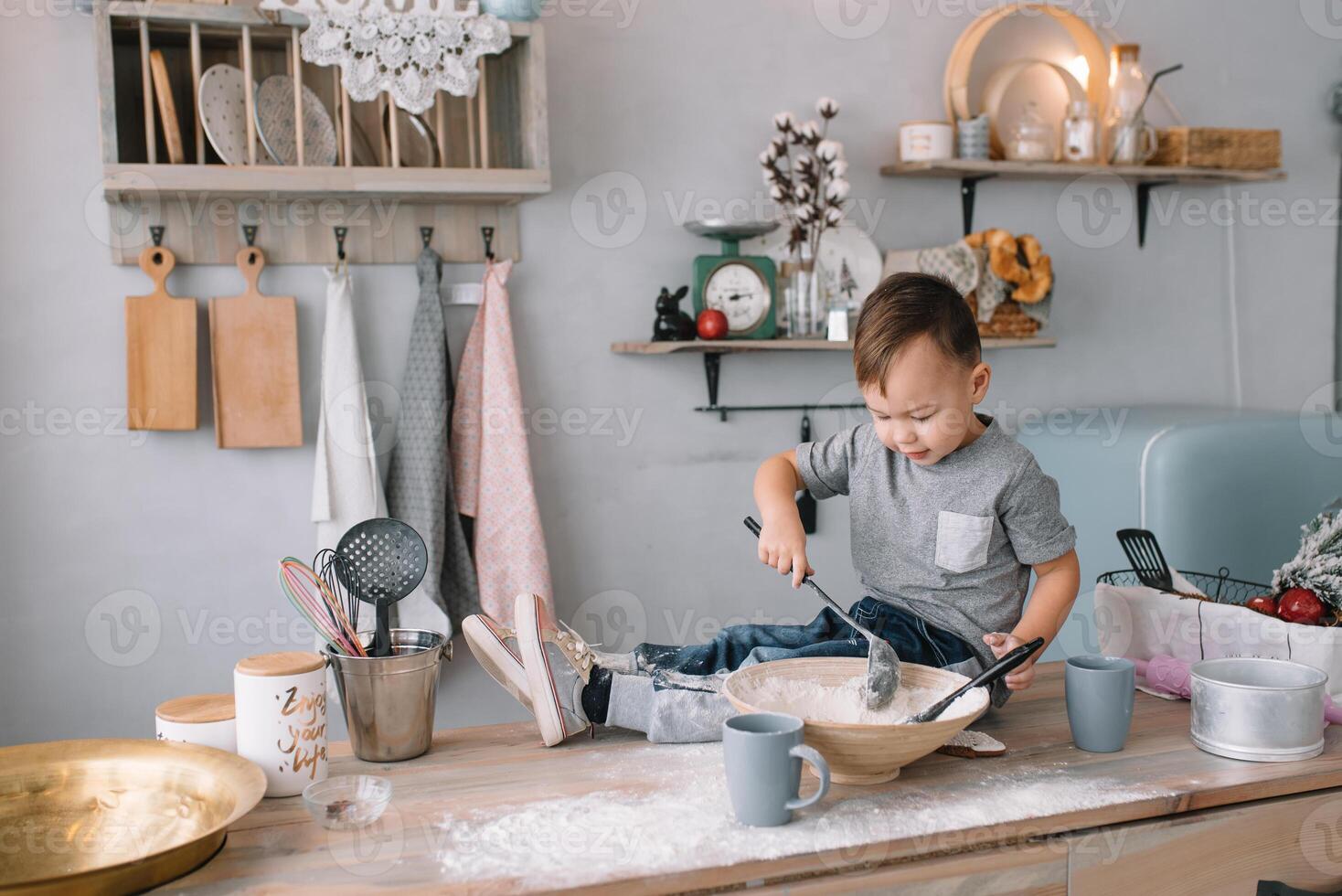 Young boy cute on the kitchen cook chef in white uniform and hat near table. homemade gingerbread. the boy cooked the chocolate cookies. photo