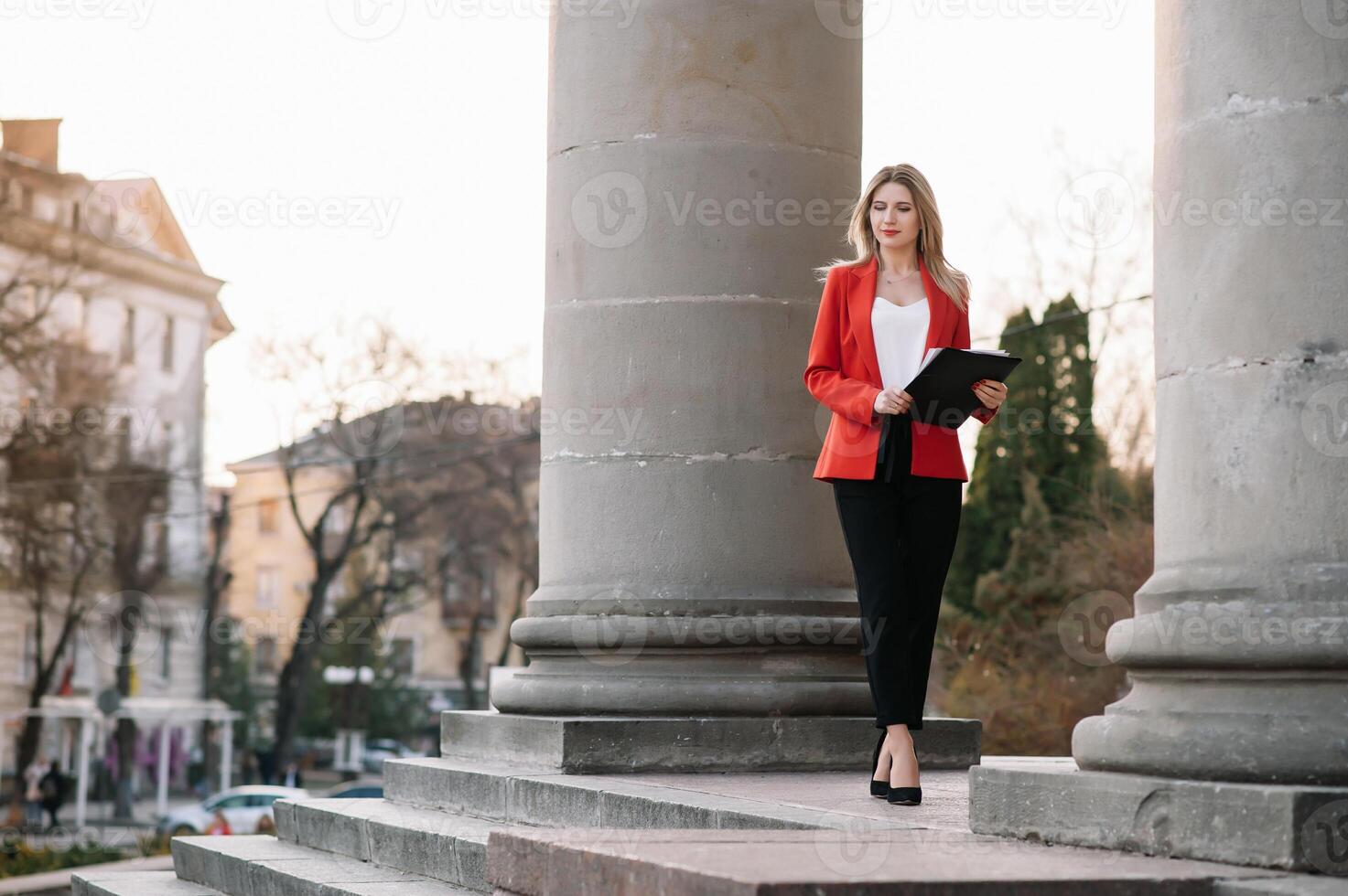 retrato de negocio mujer en sensación de concentrado estrés y ver estar y sostener el papel archivo sábana en el al aire libre peatonal caminar camino con el ciudad espacio de exterior moderno fachada edificio. foto