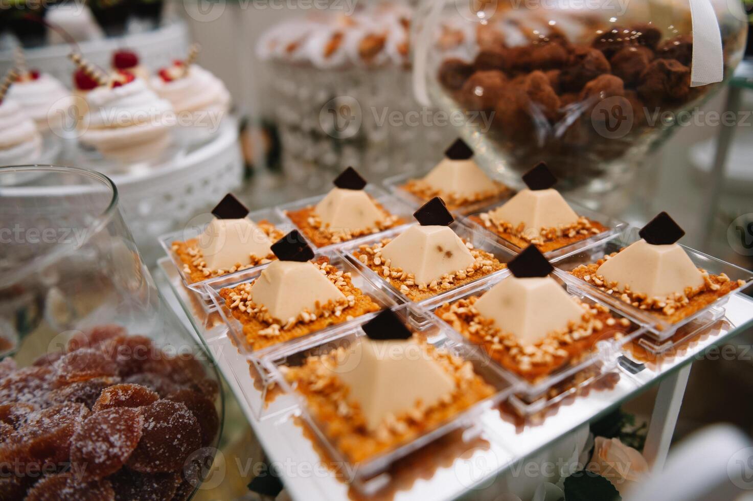 desserts with fruits, mousse, biscuits. Different types of sweet pastries, small colorful sweet cakes, macaron, and other desserts in the sweet buffet. candy bar for birthday. photo