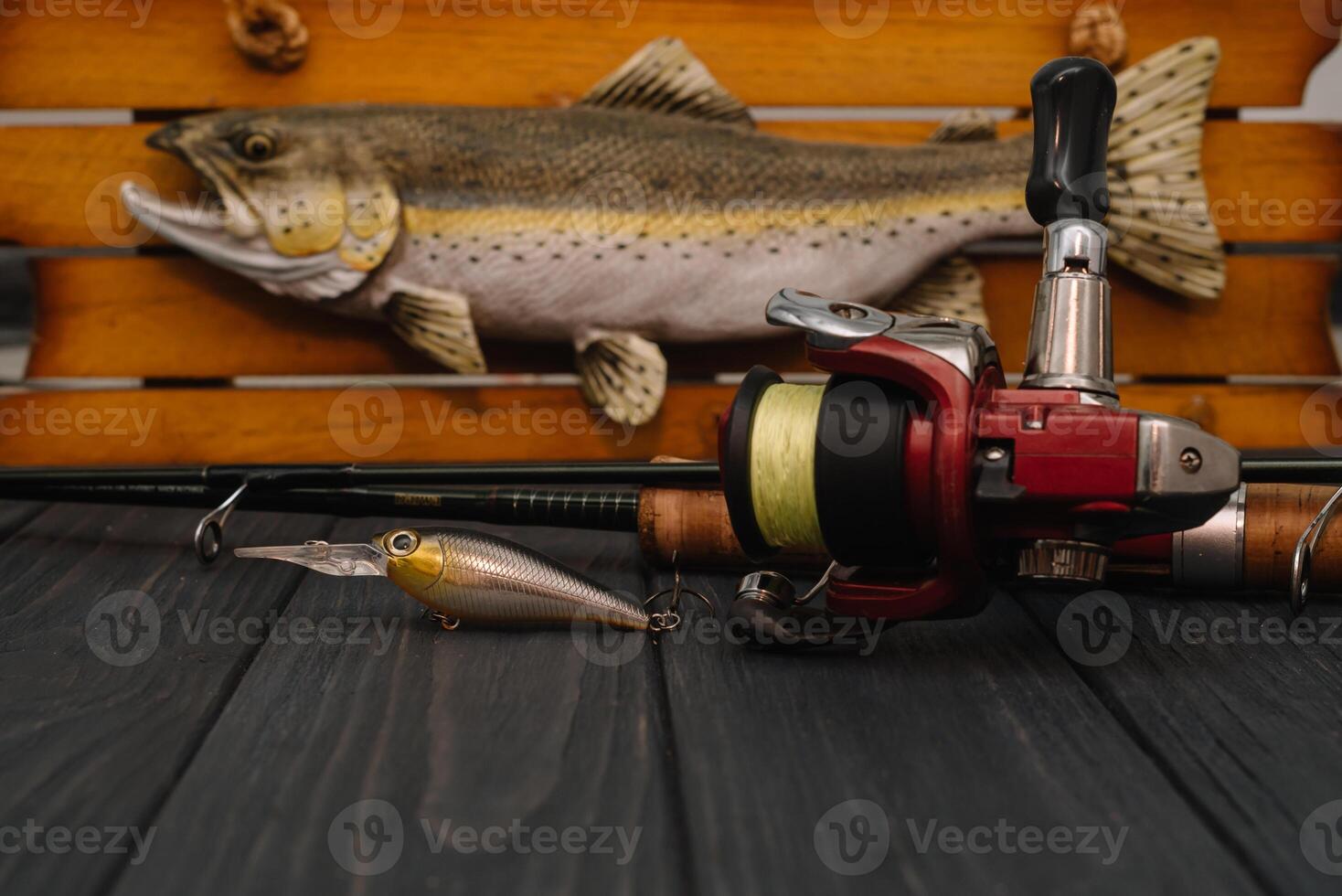 Fishing tackle - fishing spinning, hooks and lures on darken wooden background. Top view photo