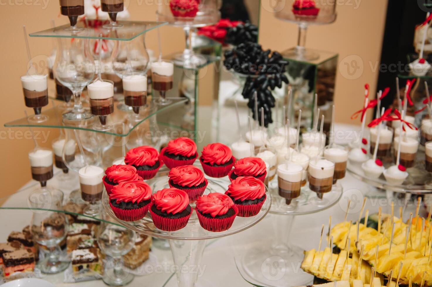 desserts with fruits, mousse, biscuits. Different types of sweet pastries, small colorful sweet cakes, macaron, and other desserts in the sweet buffet. candy bar for birthday. photo