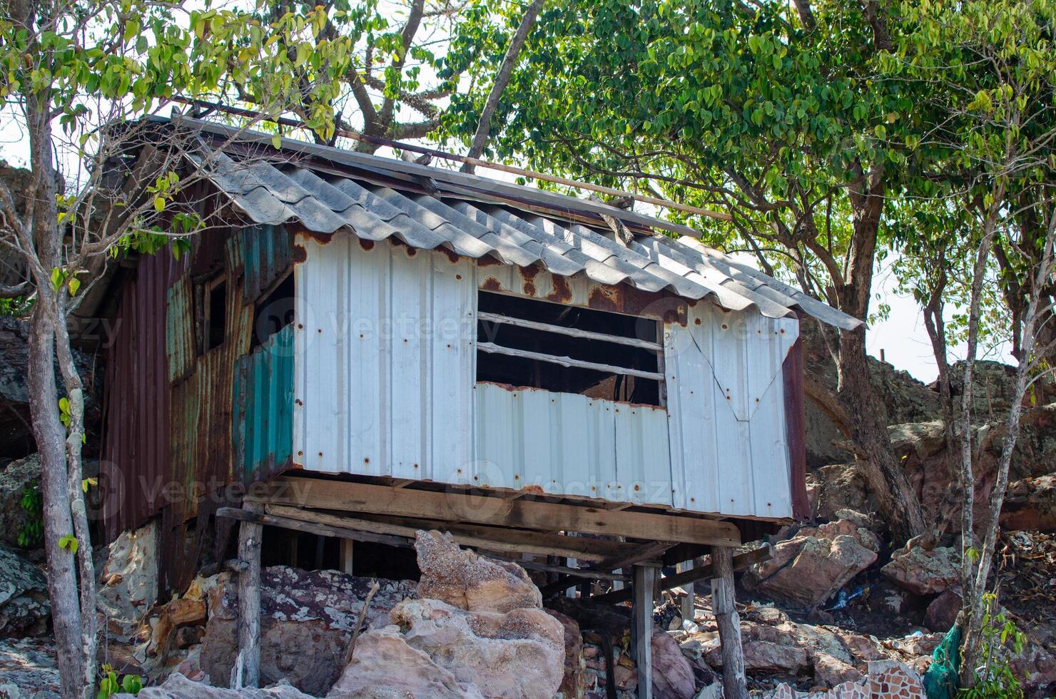 Old abandoned house on the edge of a cliff in the jungle photo