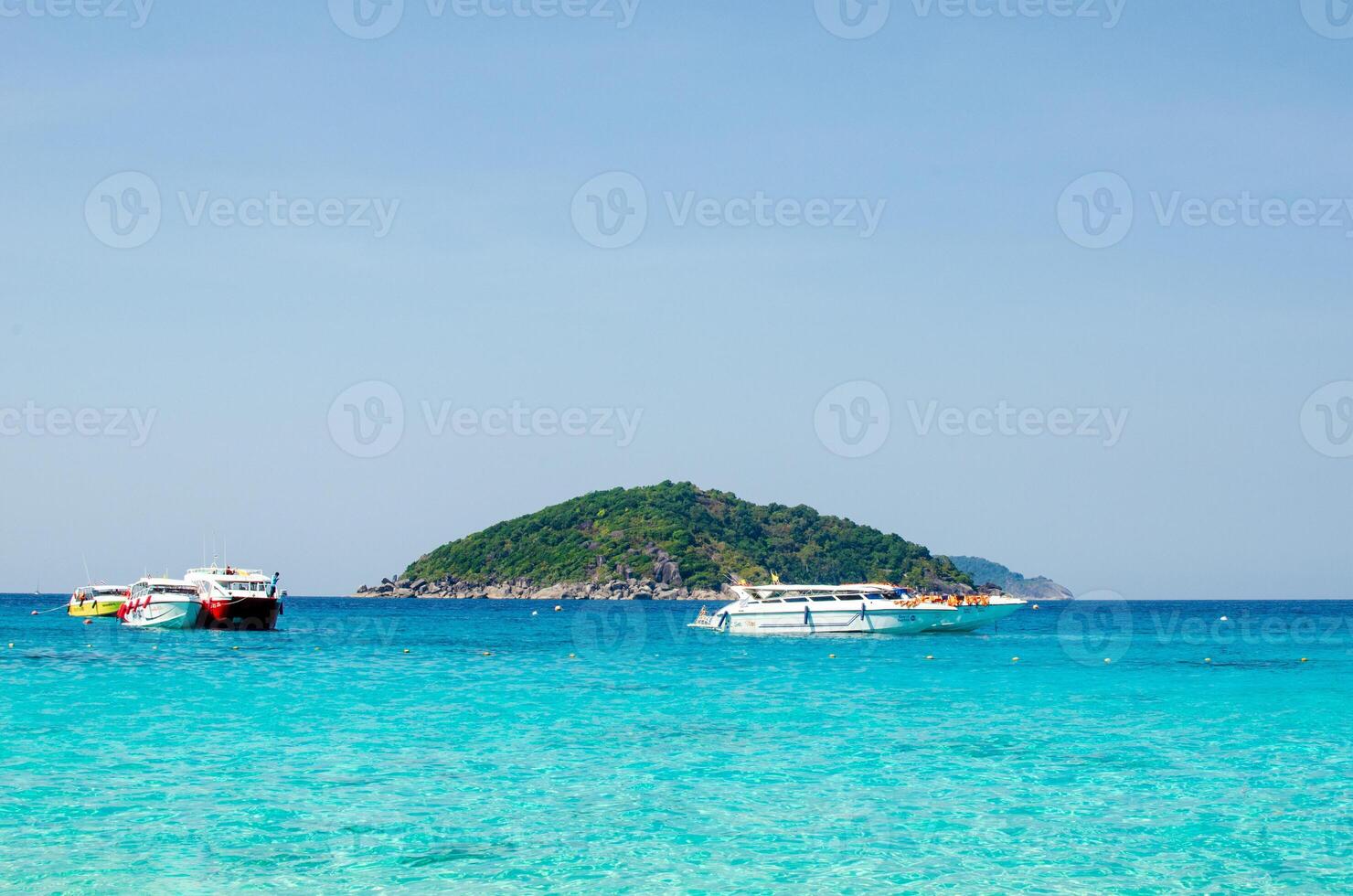 Tropical islands of ocean blue sea water and white sand beach at Similan Islands with famous Sail Rock, Phang Nga Thailand nature landscape photo