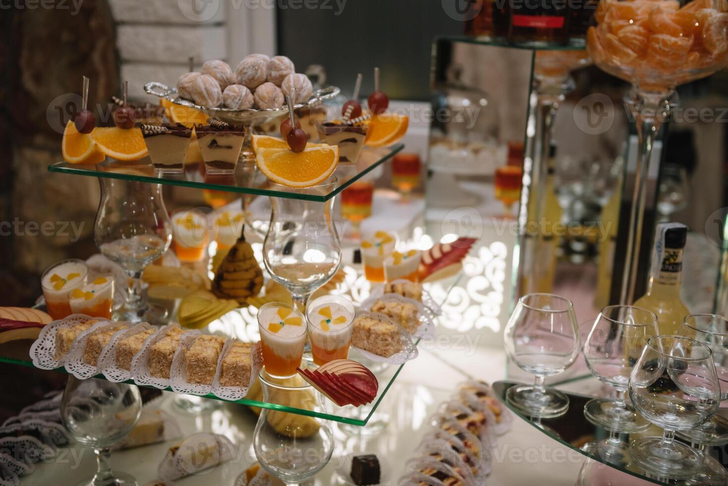 desserts with fruits, mousse, biscuits. Different types of sweet pastries, small colorful sweet cakes, macaron, and other desserts in the sweet buffet. candy bar for birthday. photo