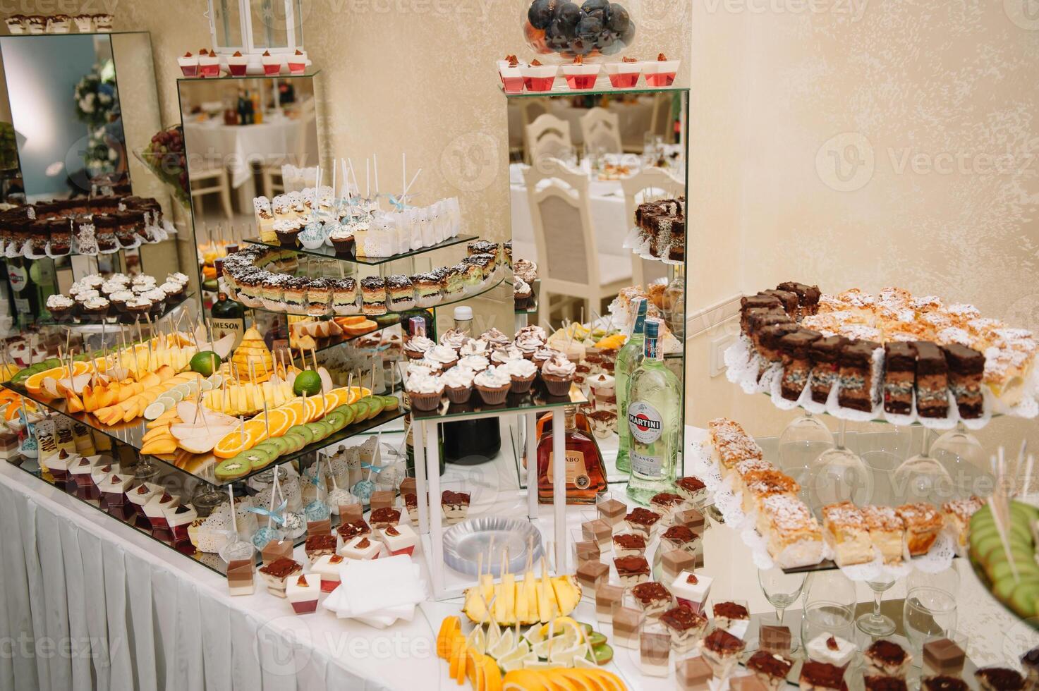 desserts with fruits, mousse, biscuits. Different types of sweet pastries, small colorful sweet cakes, macaron, and other desserts in the sweet buffet. candy bar for birthday. photo