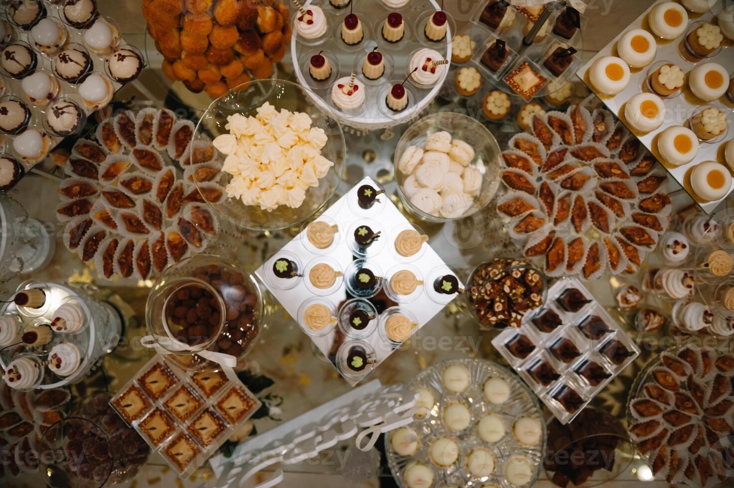 desserts with fruits, mousse, biscuits. Different types of sweet pastries, small colorful sweet cakes, macaron, and other desserts in the sweet buffet. candy bar for birthday. photo