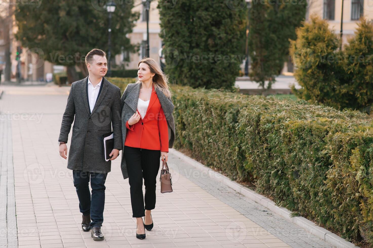 Business people walking and talking in the street. photo