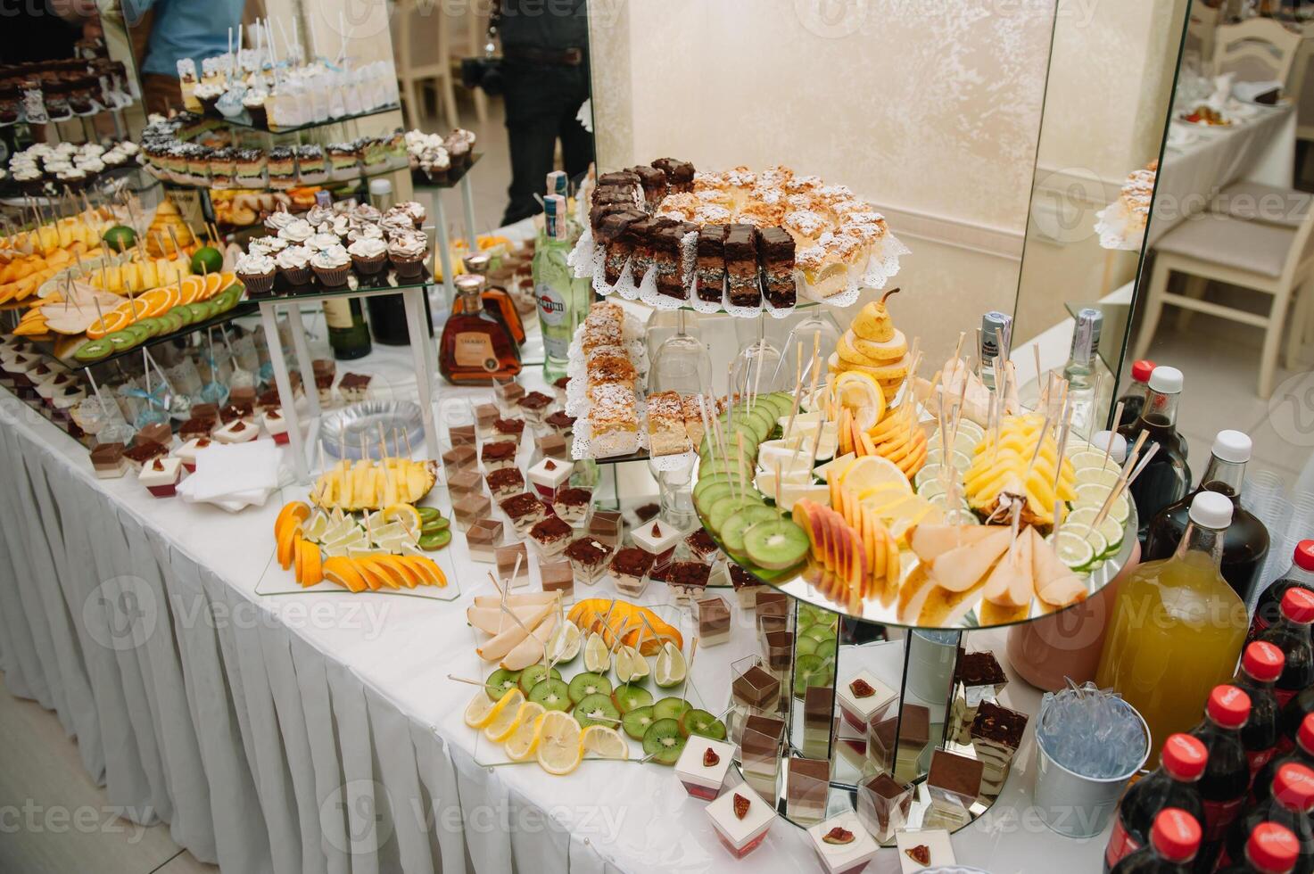 desserts with fruits, mousse, biscuits. Different types of sweet pastries, small colorful sweet cakes, macaron, and other desserts in the sweet buffet. candy bar for birthday. photo