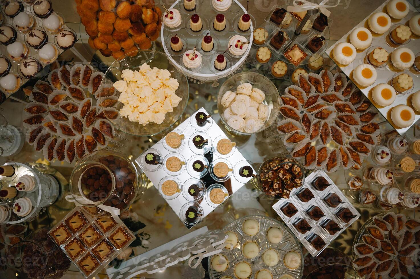 desserts with fruits, mousse, biscuits. Different types of sweet pastries, small colorful sweet cakes, macaron, and other desserts in the sweet buffet. candy bar for birthday. photo