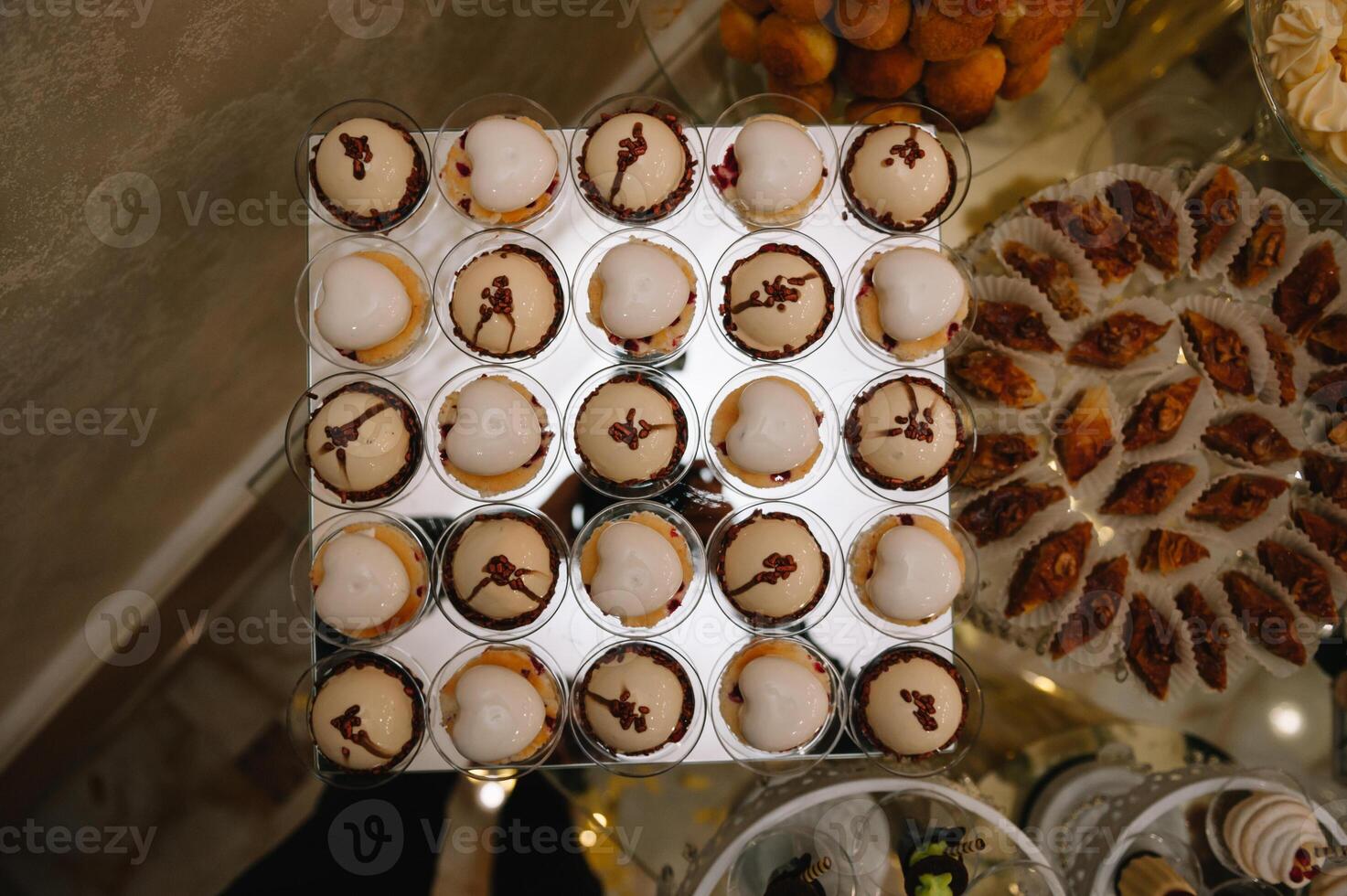 desserts with fruits, mousse, biscuits. Different types of sweet pastries, small colorful sweet cakes, macaron, and other desserts in the sweet buffet. candy bar for birthday. photo