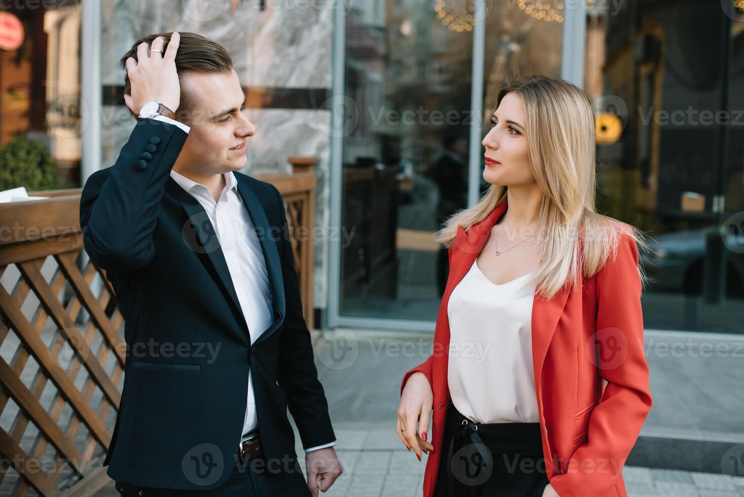 Business people walking and talking in the street ear of modern building photo