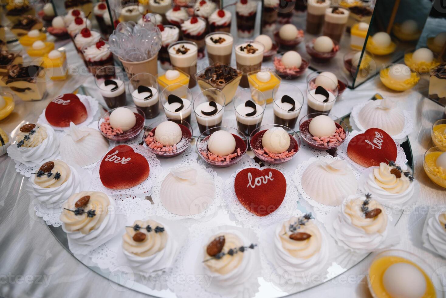 desserts with fruits, mousse, biscuits. Different types of sweet pastries, small colorful sweet cakes, macaron, and other desserts in the sweet buffet. candy bar for birthday. photo