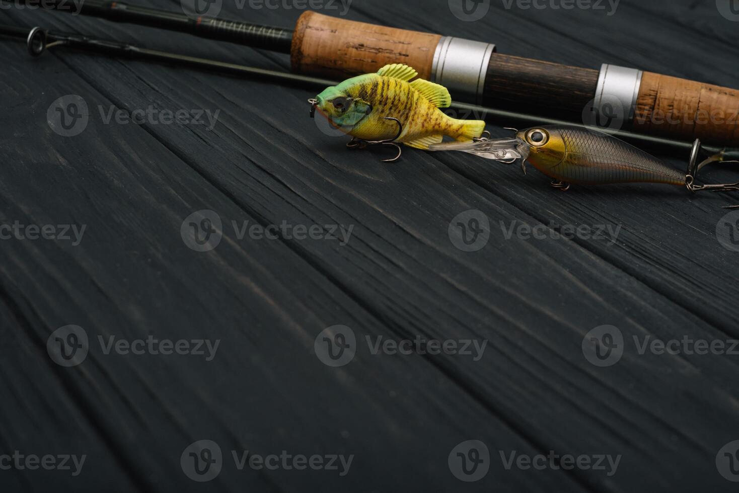 Fishing tackle - fishing spinning, hooks and lures on darken wooden background. Top view photo