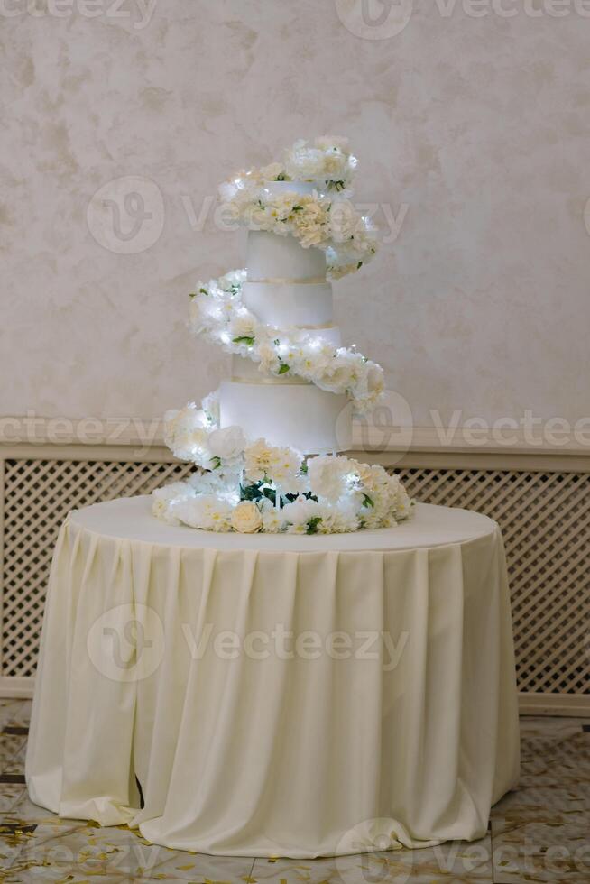 White wedding cake with flowers and blueberries photo