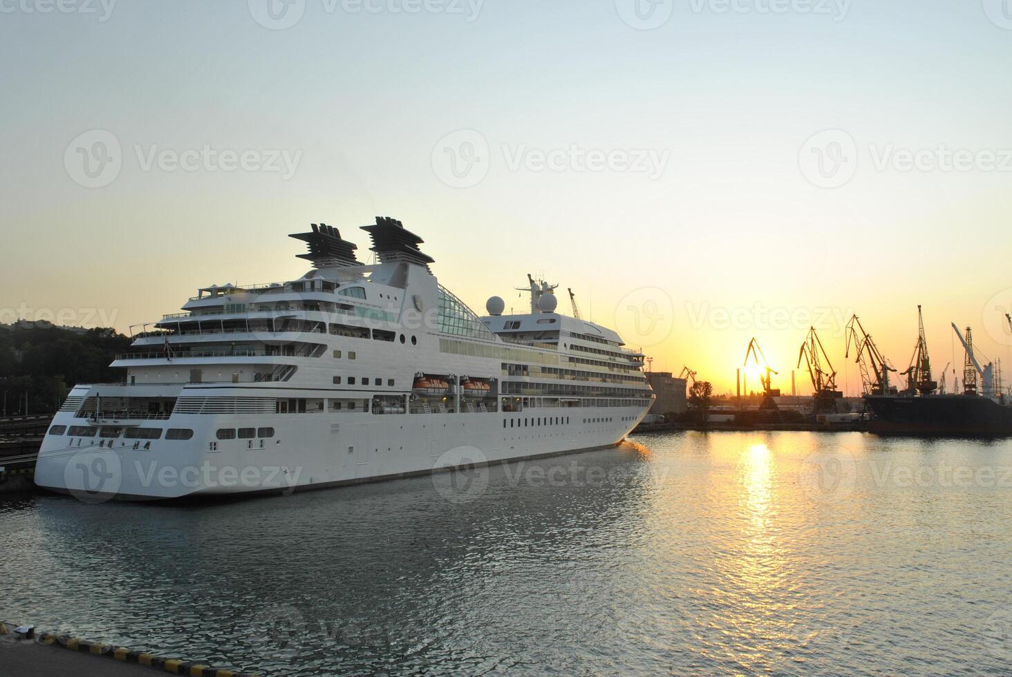 Luxury cruise ship sailing to port on sunrise. photo
