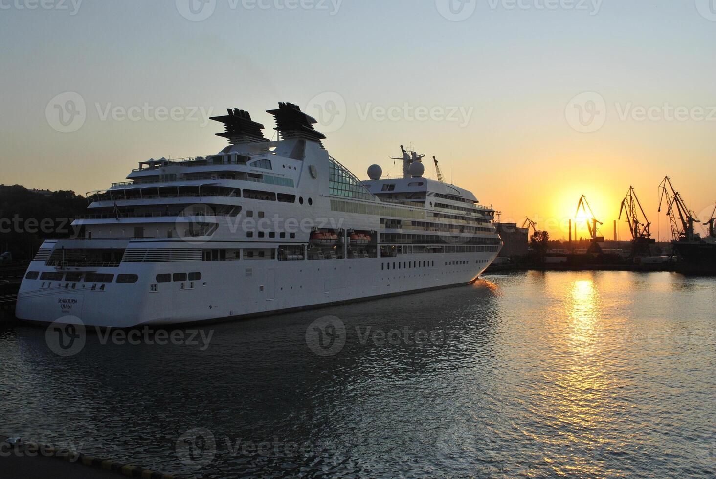 Luxury cruise ship sailing to port on sunrise. photo