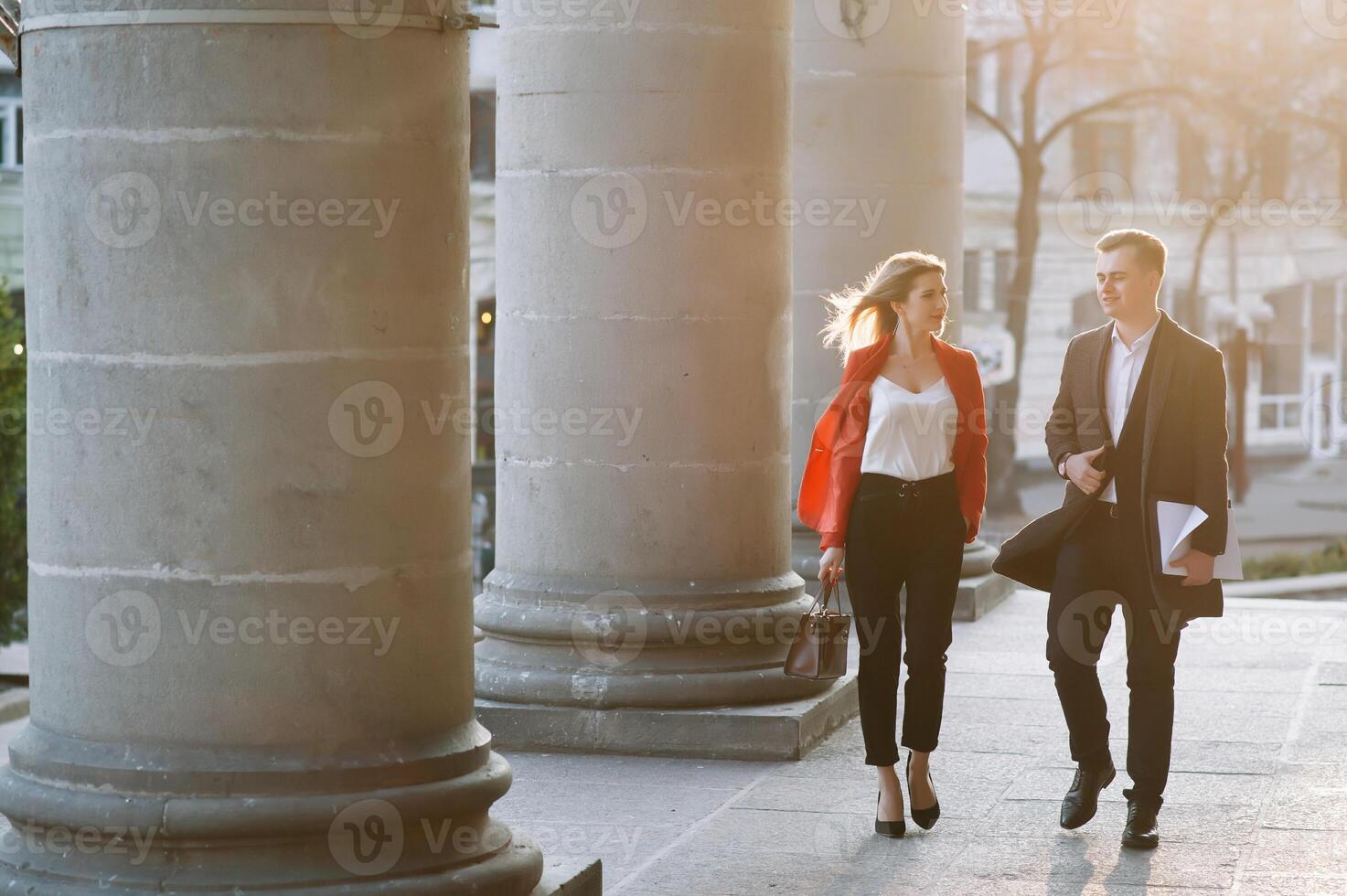 Young business people walking together along the street photo