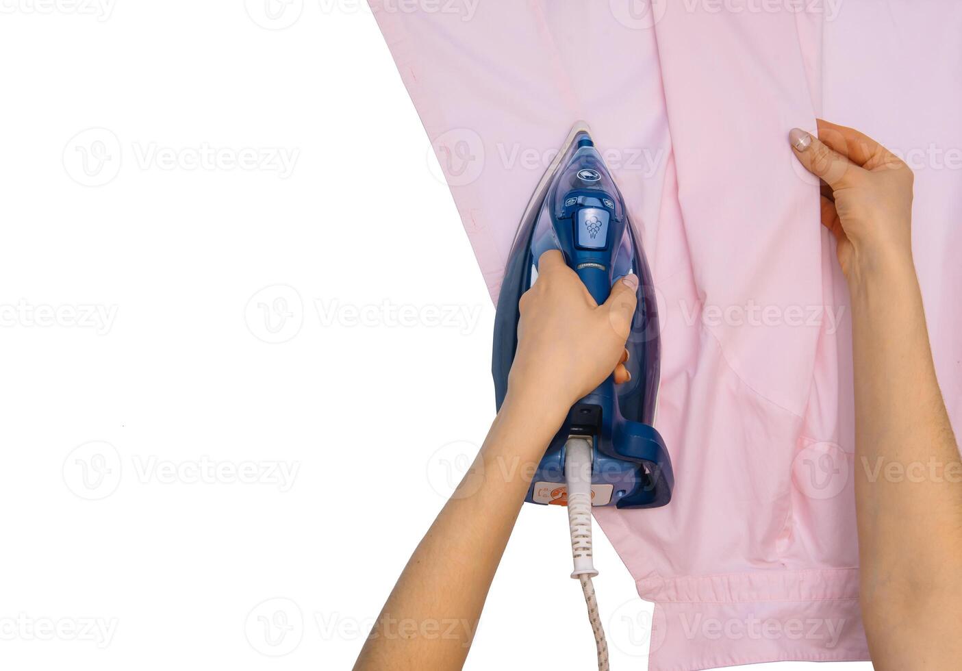 Female hand ironing clothes top view isolated on white background. Young woman with iron ironing man's shirt seen from above during housework. Blue iron on white table photo