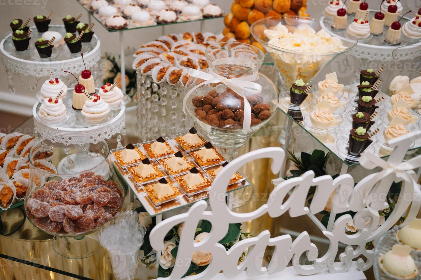 desserts with fruits, mousse, biscuits. Different types of sweet pastries, small colorful sweet cakes, macaron, and other desserts in the sweet buffet. candy bar for birthday. photo