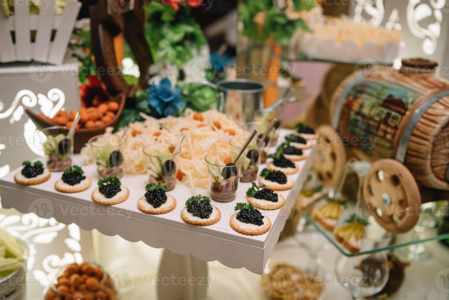 desserts with fruits, mousse, biscuits. Different types of sweet pastries, small colorful sweet cakes, macaron, and other desserts in the sweet buffet. candy bar for birthday. photo