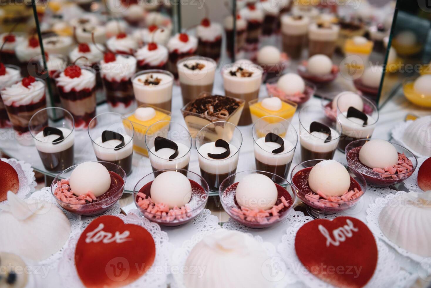 desserts with fruits, mousse, biscuits. Different types of sweet pastries, small colorful sweet cakes, macaron, and other desserts in the sweet buffet. candy bar for birthday. photo