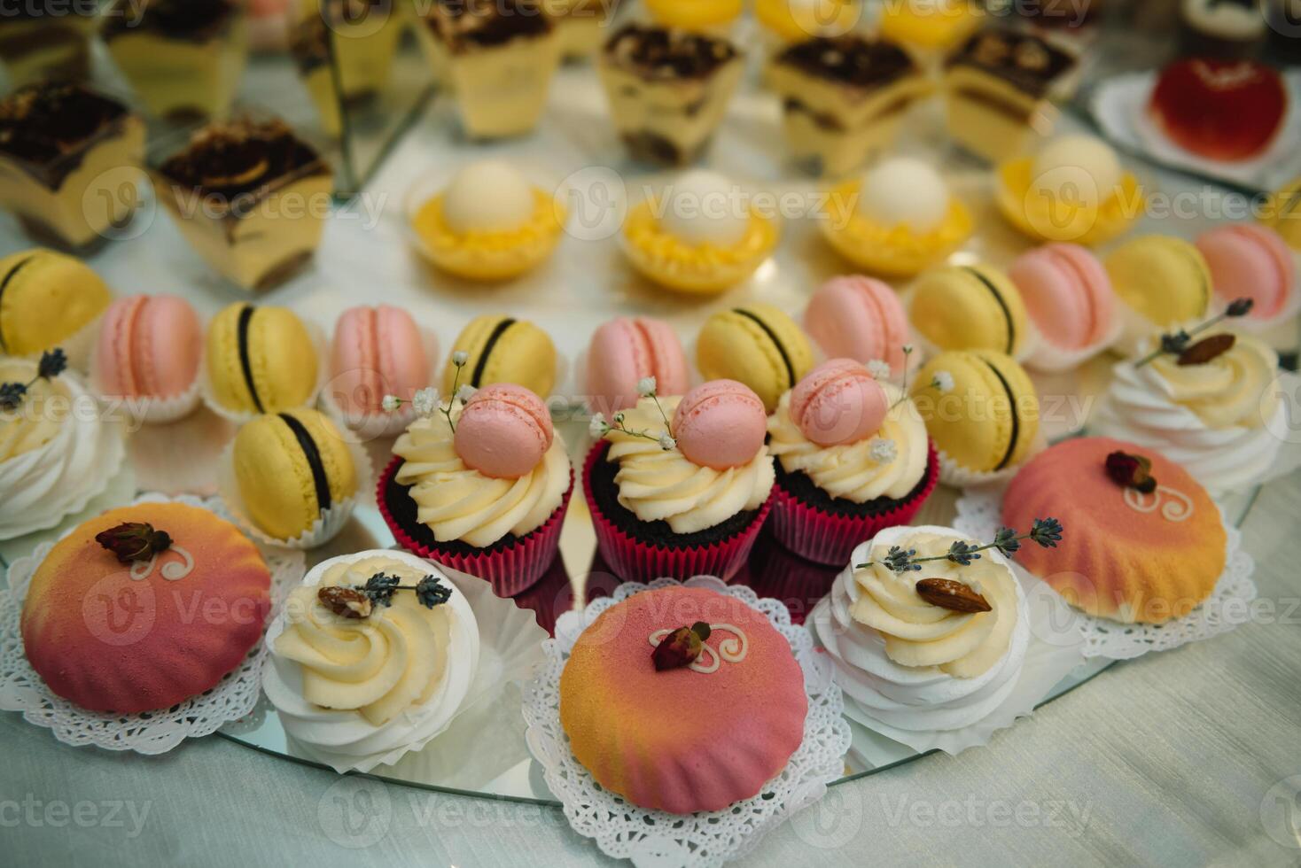 desserts with fruits, mousse, biscuits. Different types of sweet pastries, small colorful sweet cakes, macaron, and other desserts in the sweet buffet. candy bar for birthday. photo