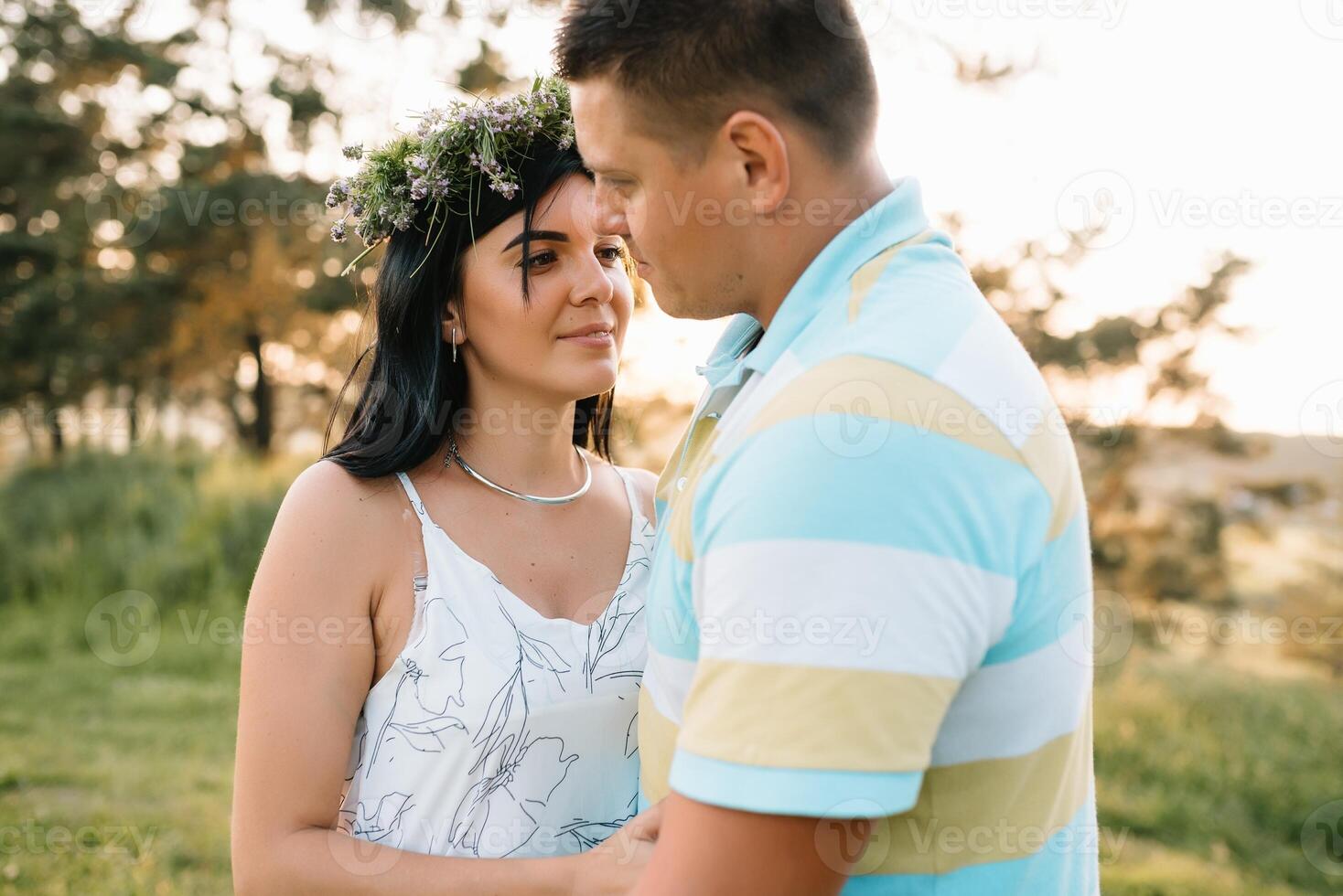 Enjoying time together. Stylish and loving couple enjoying each other by the sea. The couple is young and in love. The concept of youth, love and lifestyle. Beautiful sunset on a summer day. photo