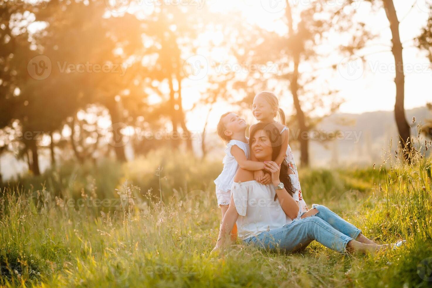 Mother and two daughters having fun in the park. Happiness and harmony in family life. Beauty nature scene with family outdoor lifestyle. photo