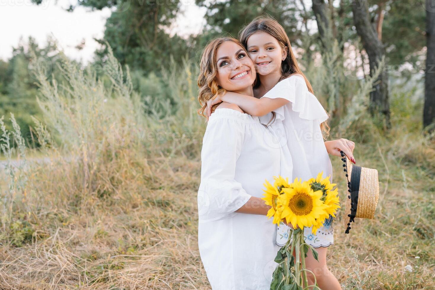 elegante madre y hermoso hija teniendo divertido en el naturaleza. contento familia concepto. belleza naturaleza escena con familia al aire libre estilo de vida. familia descansando juntos. felicidad en familia vida. madres día. foto