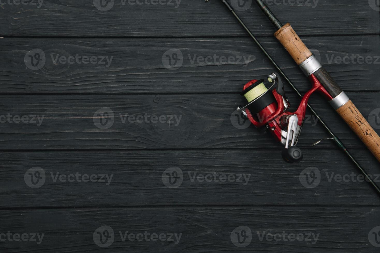 Fishing tackle - fishing spinning, hooks and lures on darken wooden background. Top view photo