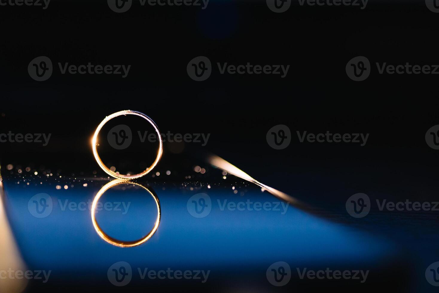 Beautiful wedding rings on light background photo