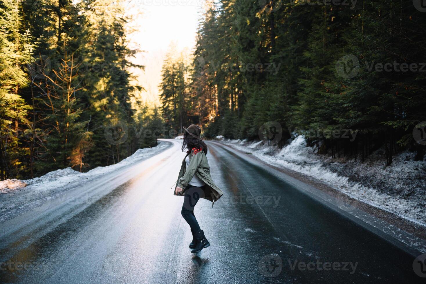 Happy girl with hat in forest at mountain road background, Relax time on holiday concept travel ,color of vintage tone and soft focus. photo