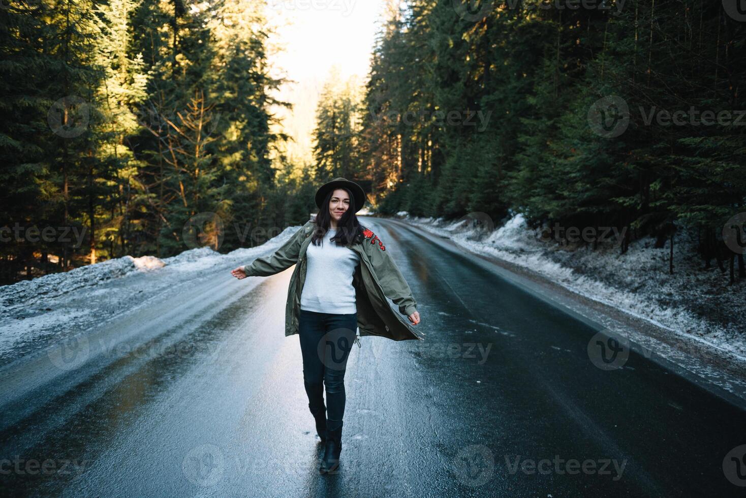 Happy girl with hat in forest at mountain road background, Relax time on holiday concept travel ,color of vintage tone and soft focus. photo