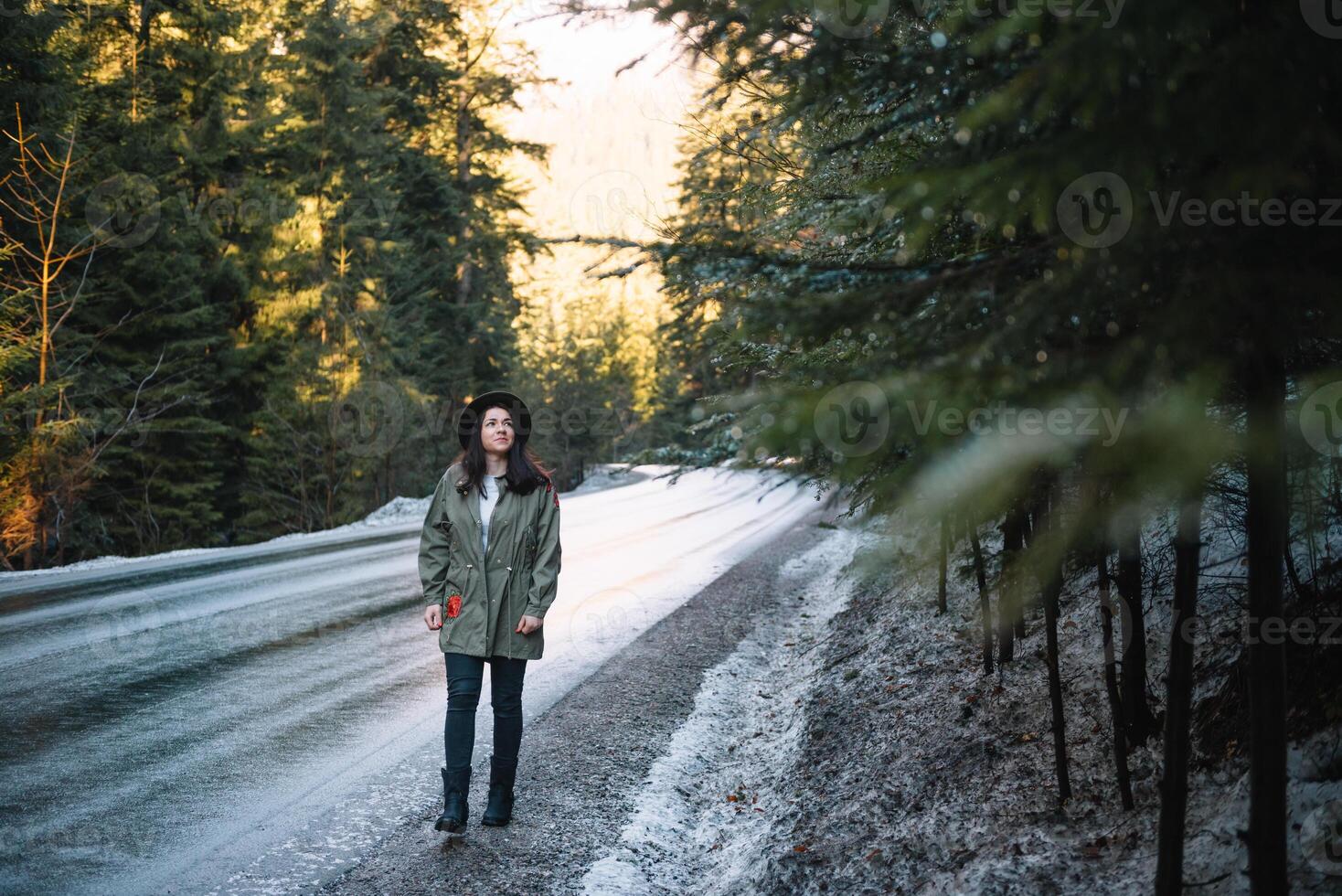 Happy girl with hat in forest at mountain road background, Relax time on holiday concept travel ,color of vintage tone and soft focus. photo