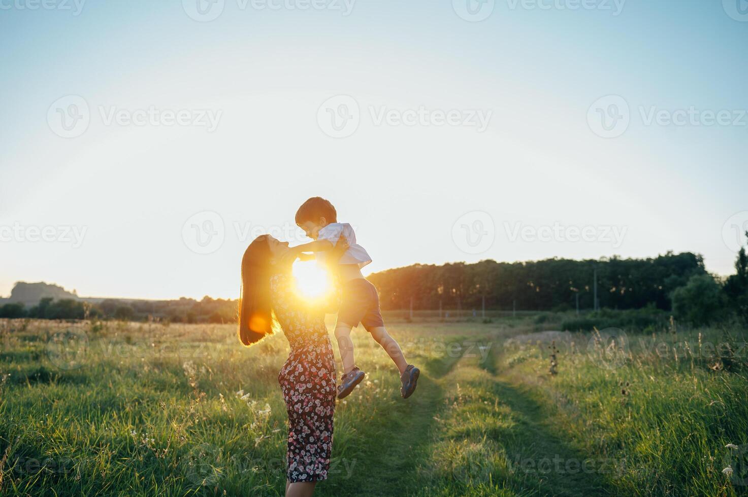 Stilish mother and handsome son having fun on the nature. Happy family concept. Beauty nature scene with family outdoor lifestyle. Happy family resting together. Happiness in family life. Mothers day. photo