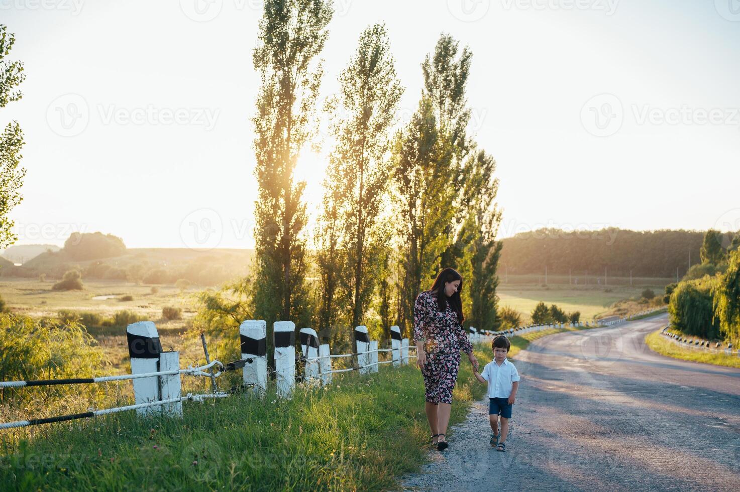 Stilish mother and handsome son having fun on the nature. Happy family concept. Beauty nature scene with family outdoor lifestyle. Happy family resting together. Happiness in family life. Mothers day. photo