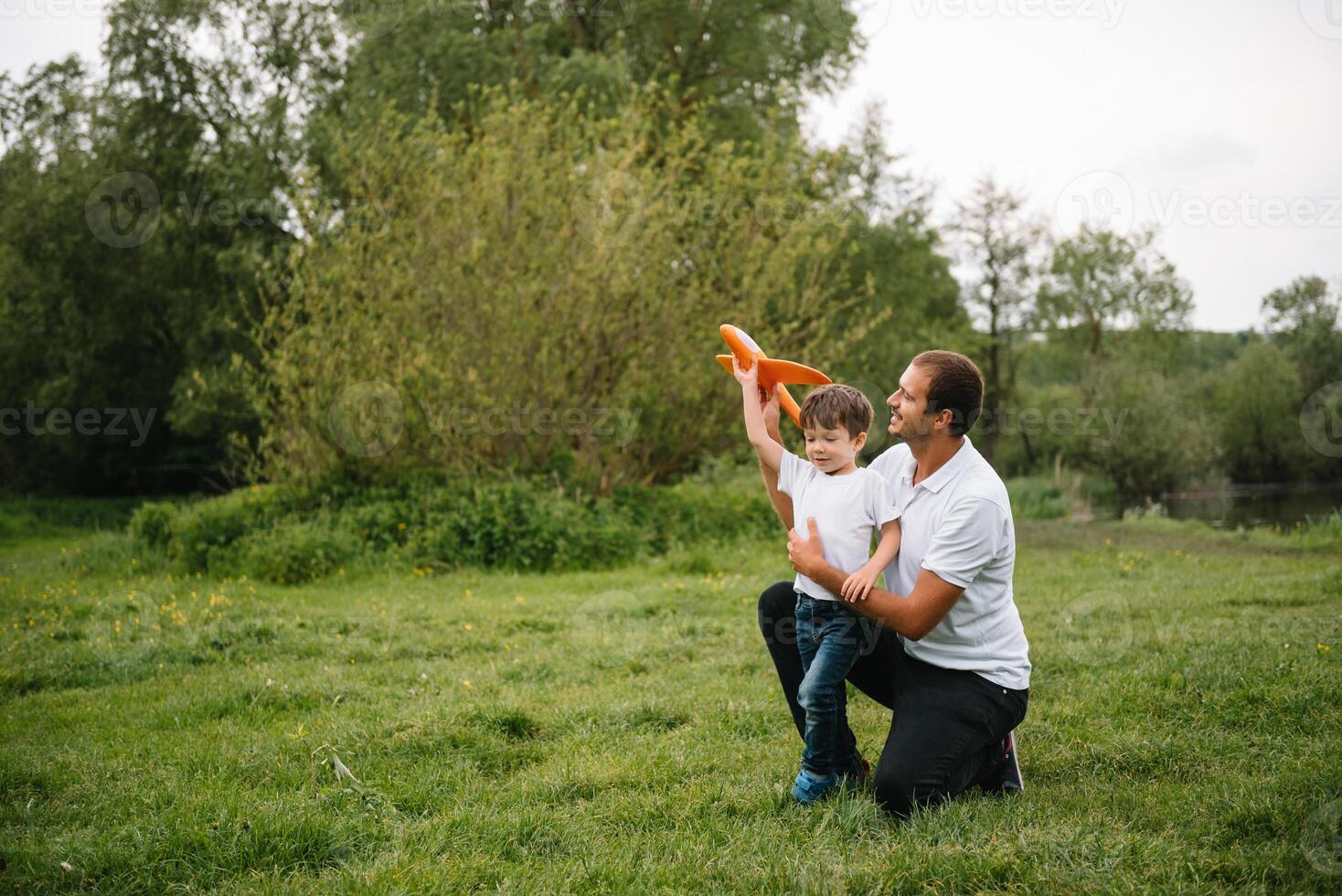 Happy man and his child having fun outdoors. Family lifestyle rural scene of father and son in sunset sunlight. concept of a happy family. photo