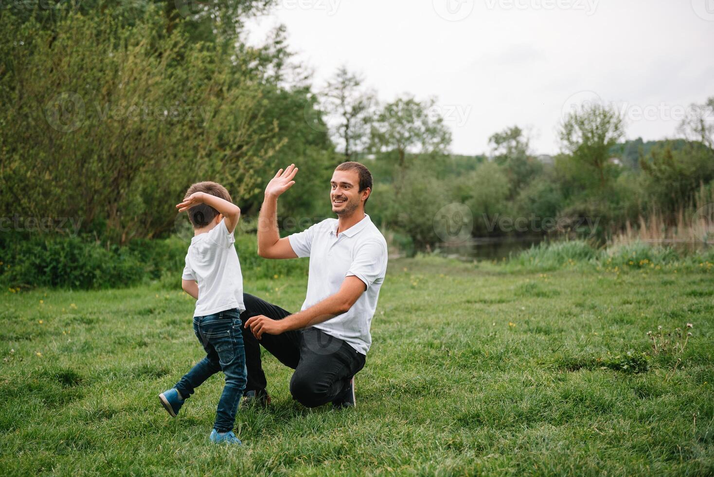 Happy man and his child having fun outdoors. Family lifestyle rural scene of father and son in sunset sunlight. concept of a happy family. photo