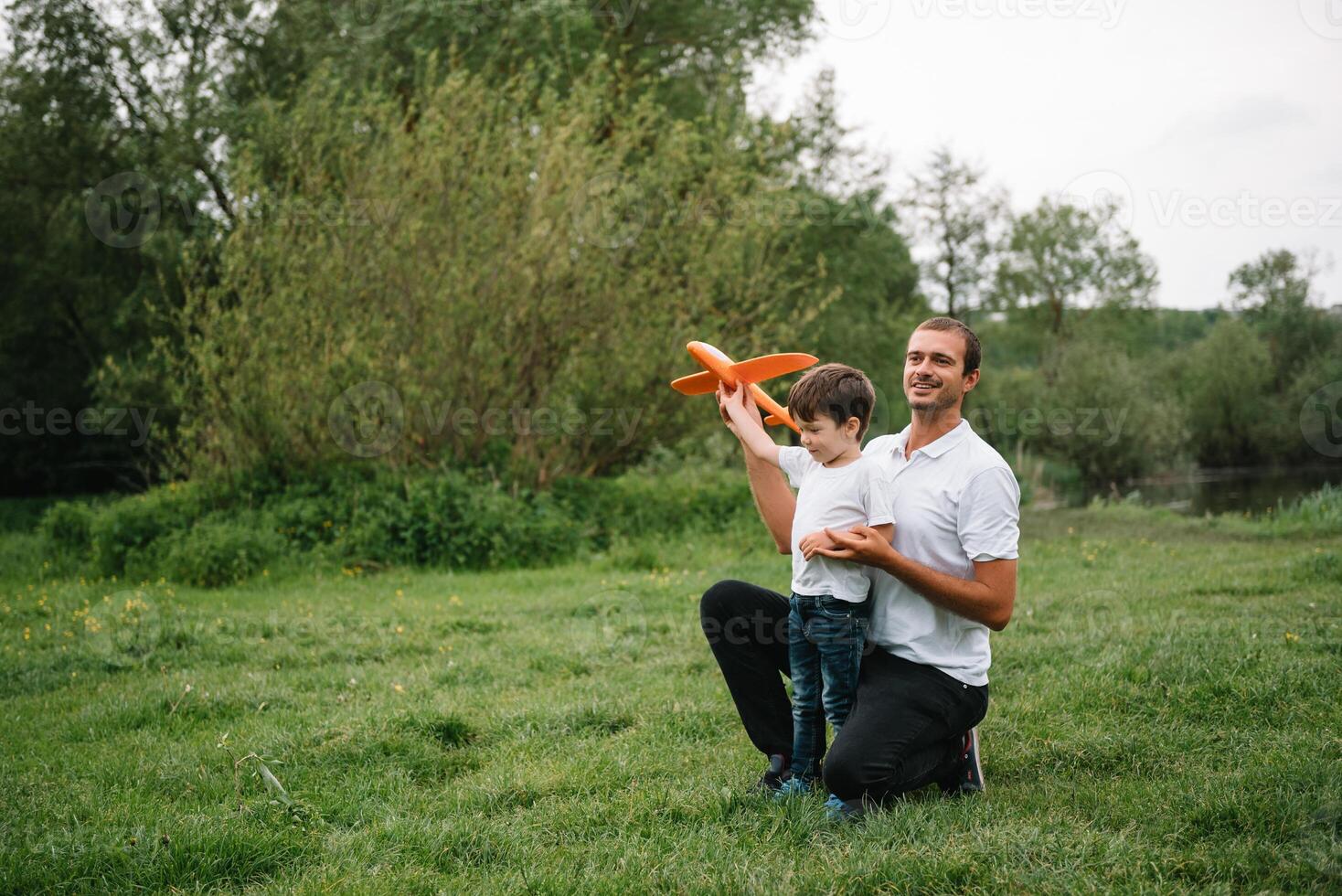 Father and son playing in aviator. Superman dad and son having fun. Imagination and dreams of being a pilot. Child pilot with airplane on dads back. Travel and vacation in summer. Freedom. photo