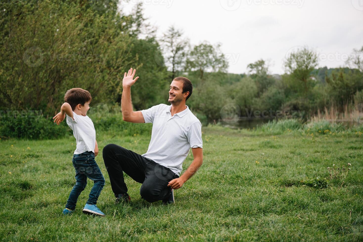 Happy man and his child having fun outdoors. Family lifestyle rural scene of father and son in sunset sunlight. concept of a happy family. photo